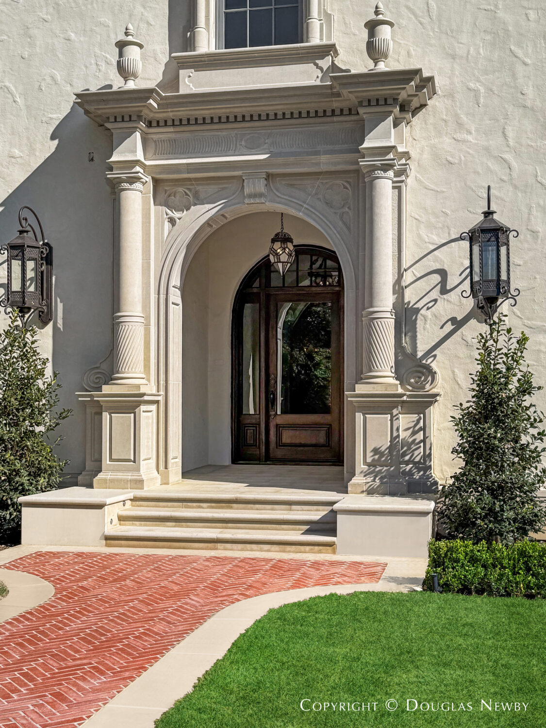 Carved stone front entrance to the Spanish Revival style estate home at 4400 Belfort Place in Highland Park, Dallas, Texas.