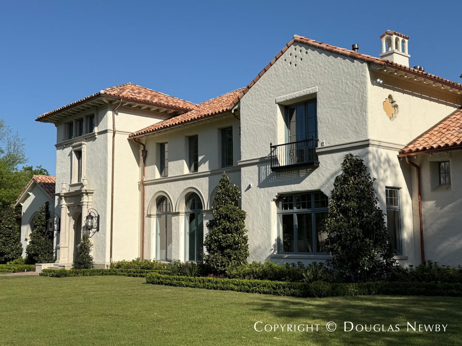 Partial exterior of Spanish Revival estate home located at 4400 Belfort Place in Highland Park, Dallas, Texas.