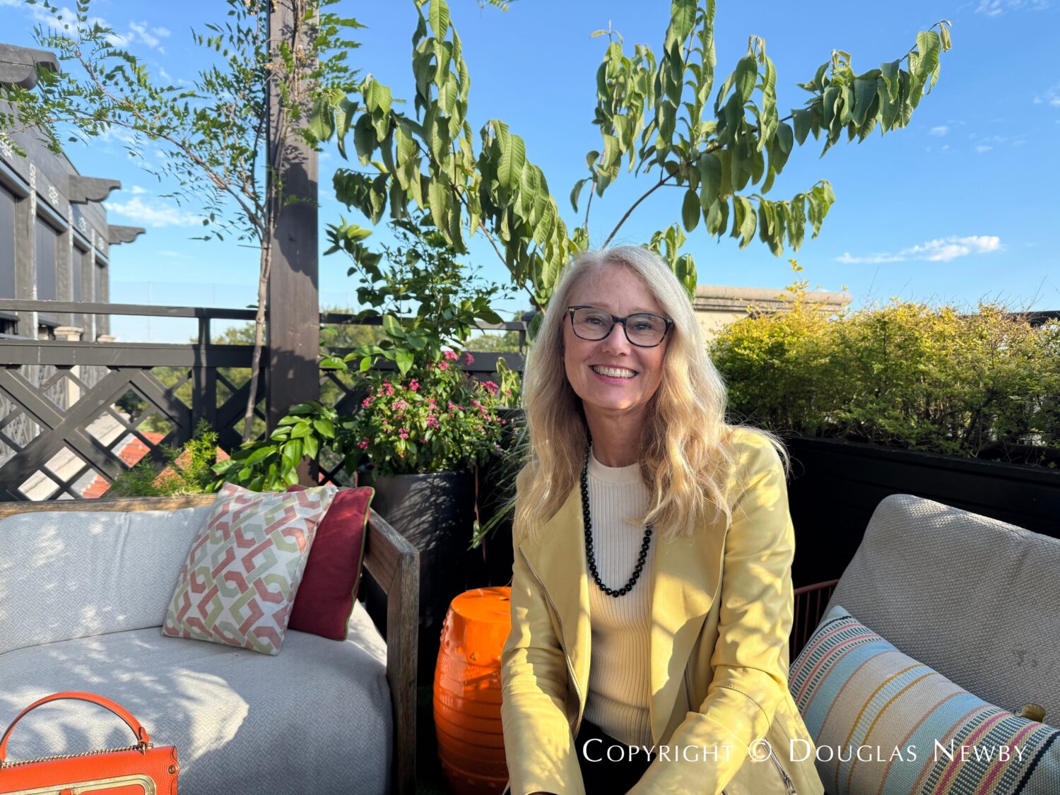 Carol Anderson, a member of Park House in Highland Park Village, enjoys an autumn afternoon on the balcony.